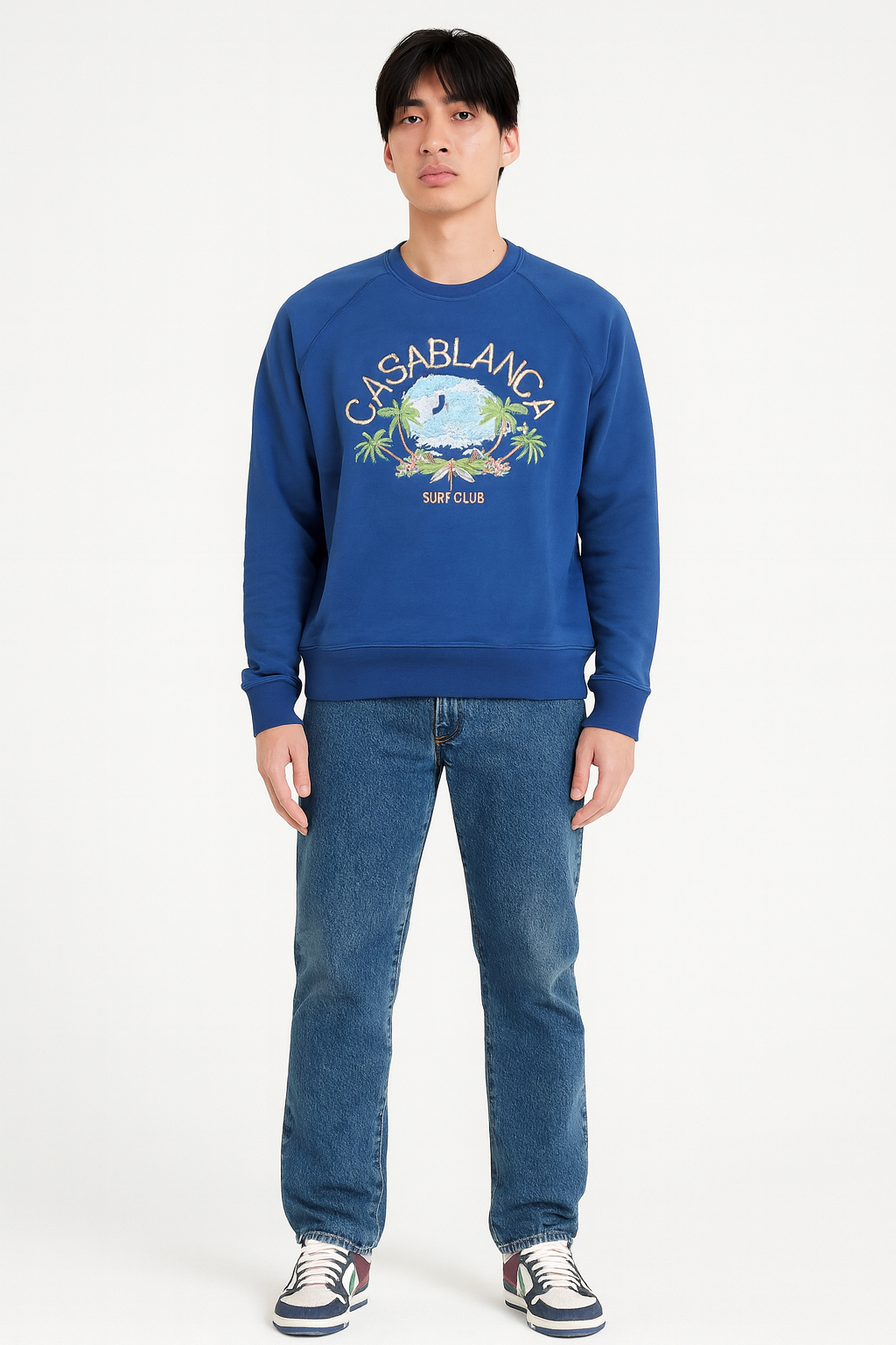 Person wearing a blue sweatshirt with 'Casablanca Surf Club' graphic on a white background