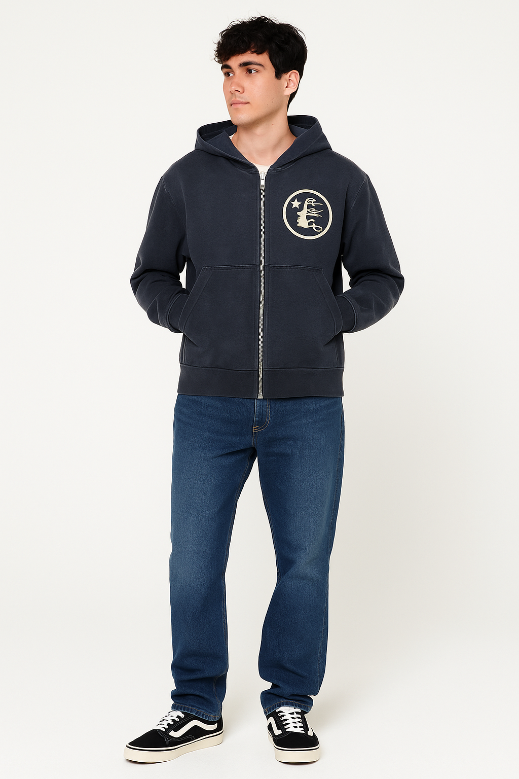 Person wearing a navy hoodie with a logo and blue jeans on a white background
