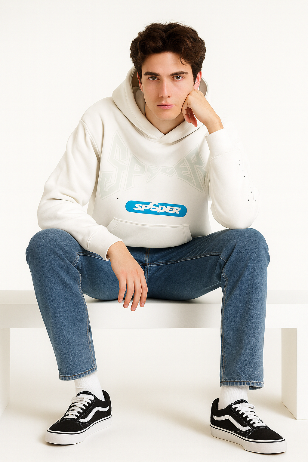Person wearing a white hoodie with a Spider logo, blue jeans, and black sneakers on a white background